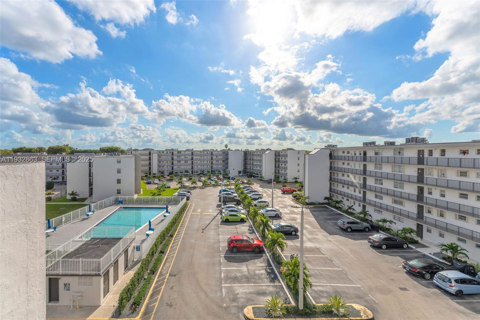 An elevated view shows a swimming pool and a parking lot between apartment buildings — 14180 SW 84th St # G, Miami FL 33183, MIAMI, FL