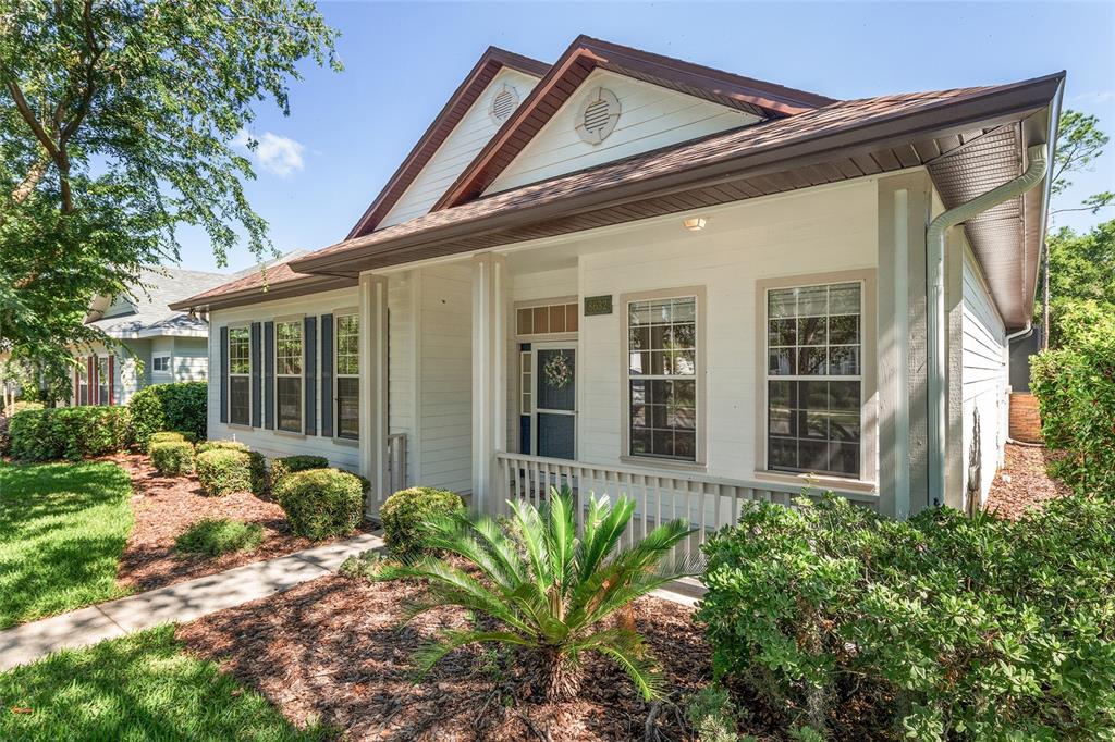 A single-story house with white siding, a front porch, and a landscaped yard — 8632 SW 76TH PLACE, GAINESVILLE, FL