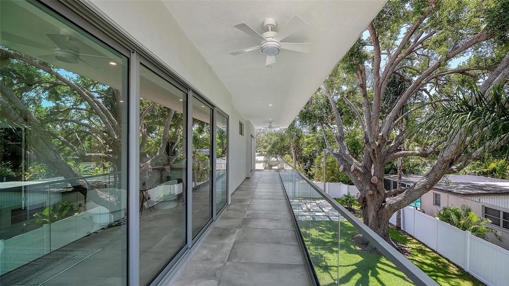 A modern two-story house with a pool, spa, and large tree in the backyard — 2010 HYDE PARK CIRCLE, SARASOTA, FL