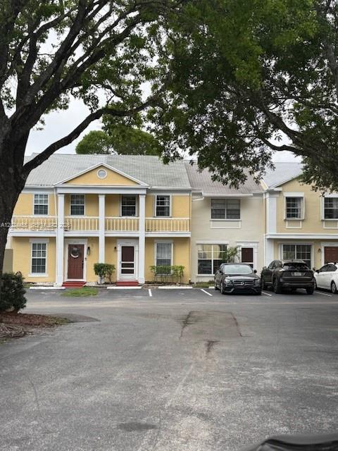 A multi-story yellow residential building with white trim and a parking lot in front — 2856 Cambridge Ln, Cooper City FL 33026, COOPER CITY, FL