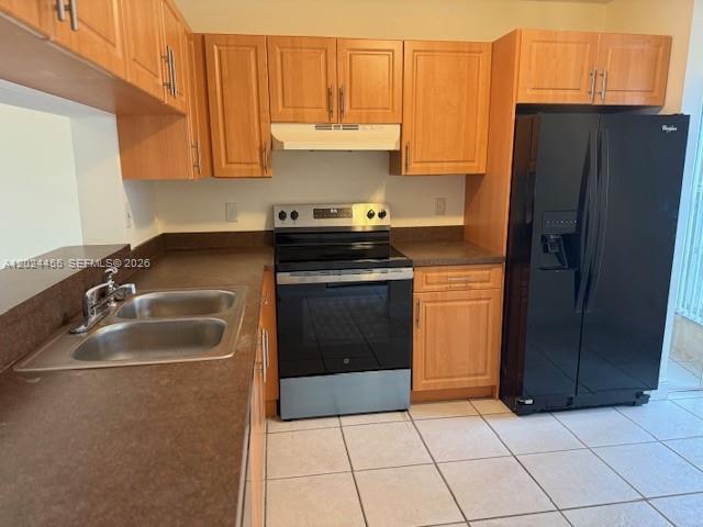 A kitchen features light wood cabinets, a black refrigerator, a stove, and a double sink — 2856 Cambridge Ln, Cooper City FL 33026, COOPER CITY, FL