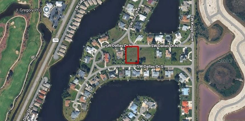 This is an aerial map view of a vacant residential lot outlined in red — 11663 SW DALLAS DRIVE N, LAKE SUZY, FL