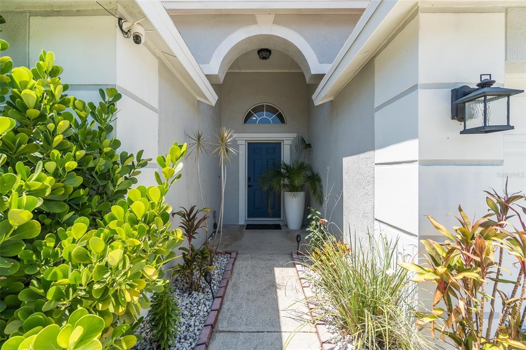 A concrete walkway leads to a blue front door under a covered entryway — 1707 BONDURANT WAY, BRANDON, FL