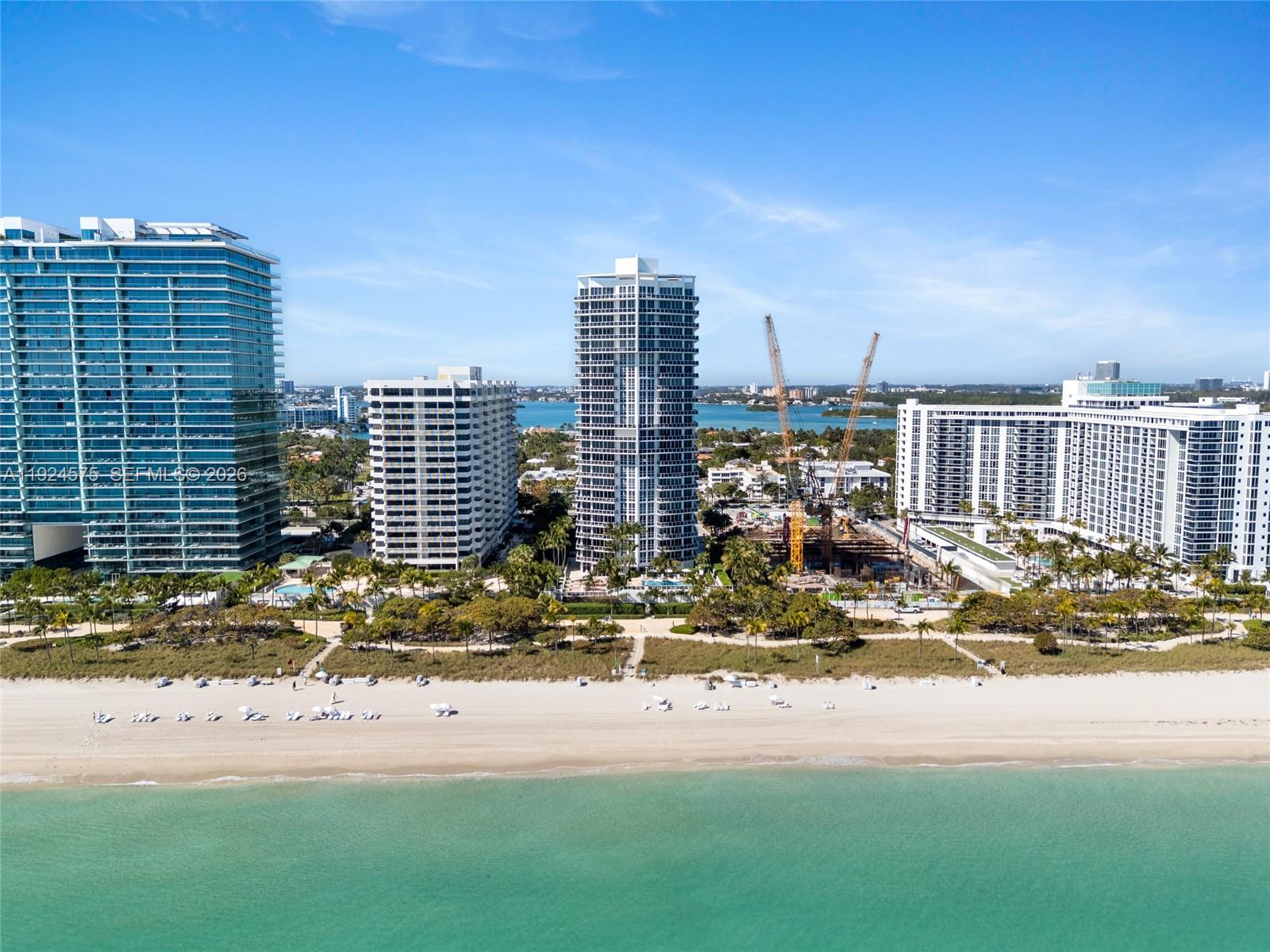 An aerial view shows several high-rise buildings along a sandy beach and turquoise ocean — 10225 Collins Ave # 404, Bal Harbour FL 33154, BAL HARBOUR, FL