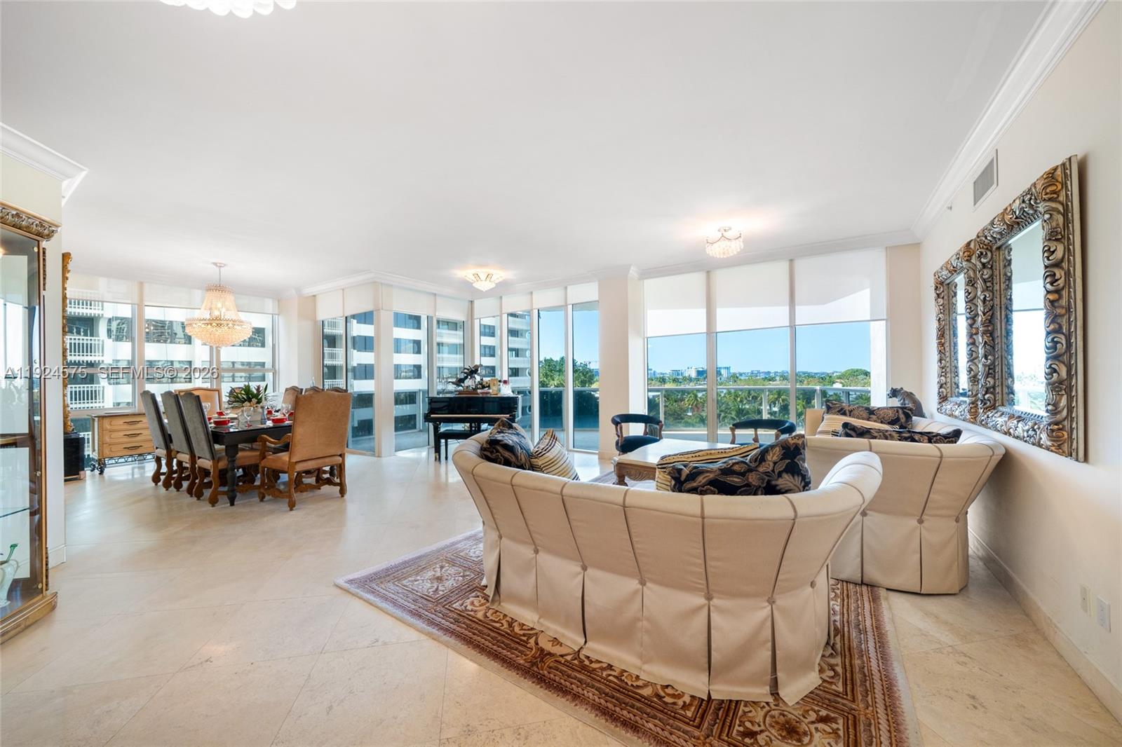 A spacious living and dining area features tile floors, a grand piano, and floor-to-ceiling windows — 10225 Collins Ave # 404, Bal Harbour FL 33154, BAL HARBOUR, FL
