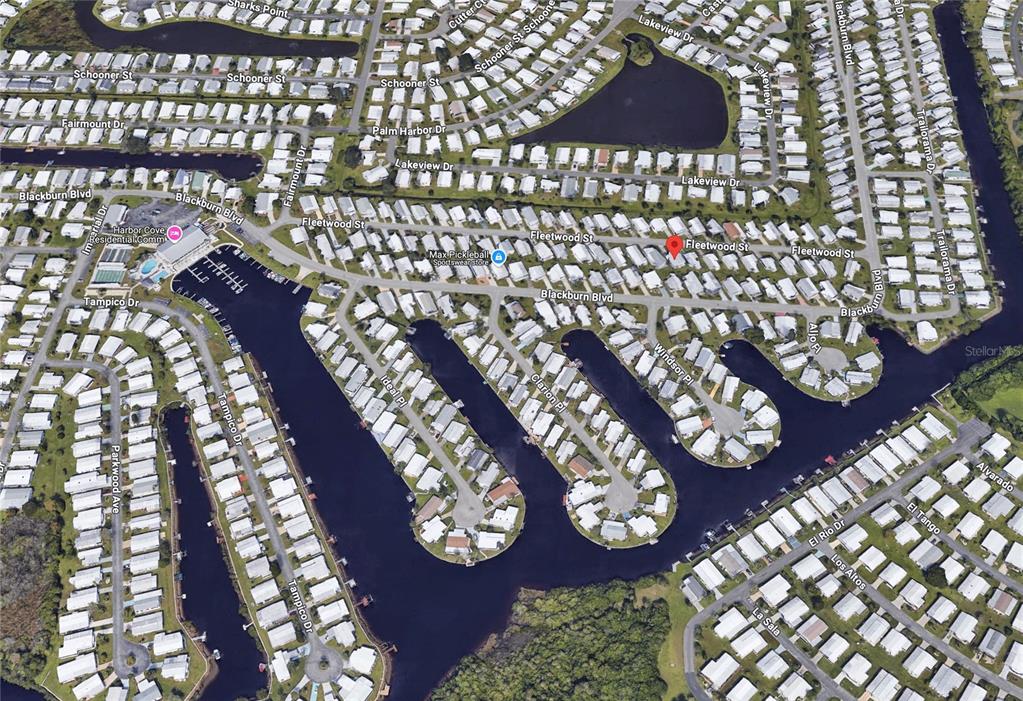 This is an aerial map view of a residential neighborhood with houses and canals — 519 FLEETWOOD STREET, NORTH PORT, FL