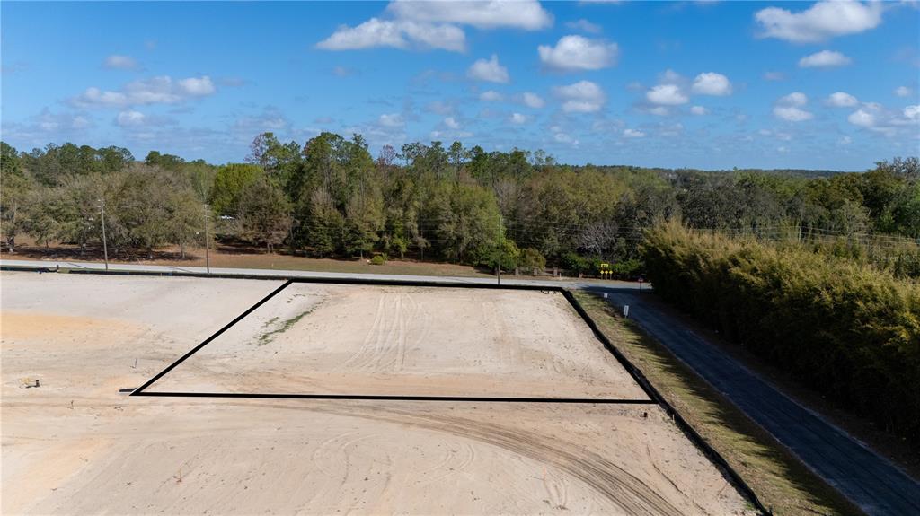 An aerial view shows a cleared, rectangular plot of land outlined in black — 12919 POMPANIC STREET, SAN ANTONIO, FL
