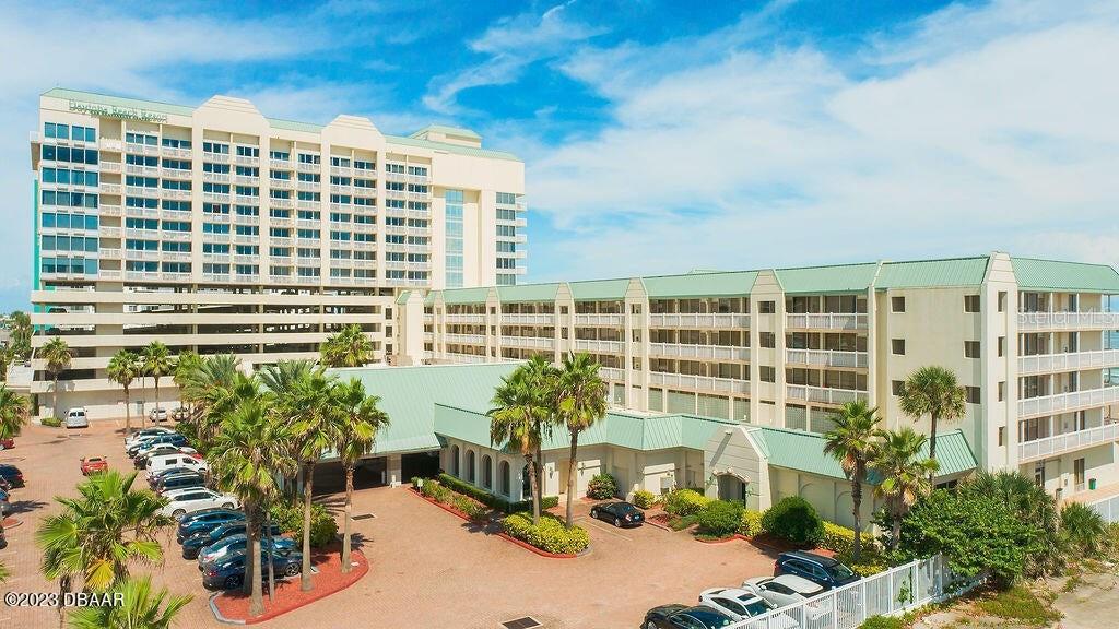 An exterior view of a large multi-story resort building with a parking lot and palm trees — 2700 N ATLANTIC AVENUE UNIT 342, DAYTONA BEACH, FL