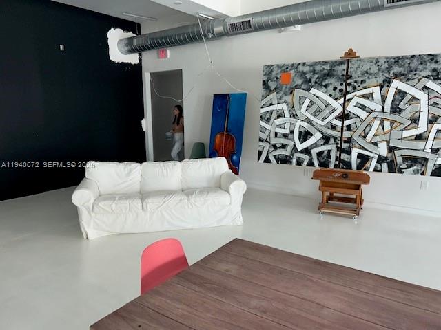 A white sofa sits in a room with a large abstract painting and exposed ductwork — 5600 NW 7 Ave, Miami FL 33127, MIAMI, FL