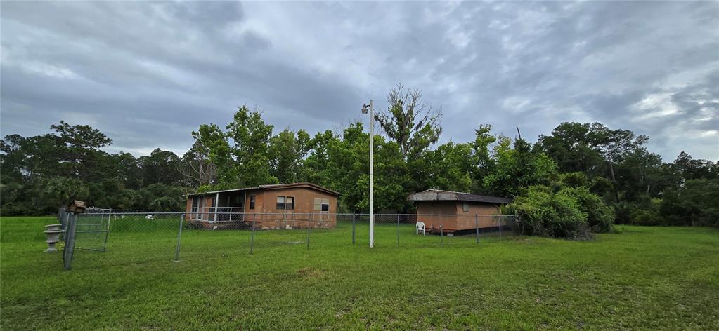 Two mobile homes sit on a grassy lot enclosed by a chain-link fence — 6150 SW 126TH AVENUE, CEDAR KEY, FL