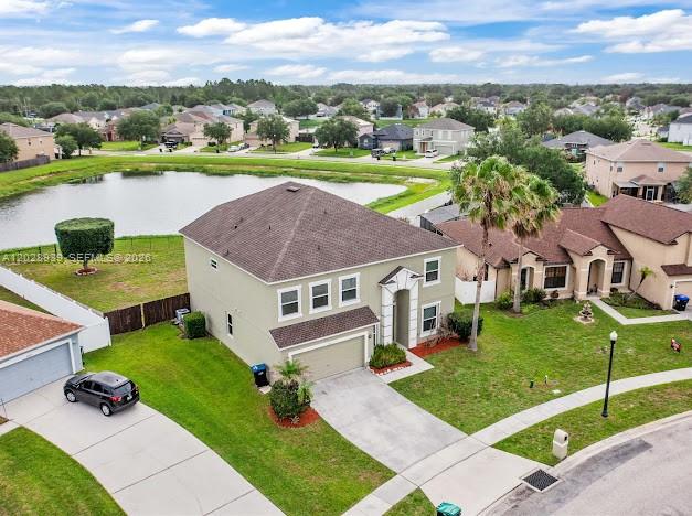 A two-story house with a beige stucco exterior, a garage, and a palm tree — 2813 Village Pine Ter, Orlando FL 32833, ORLANDO, FL