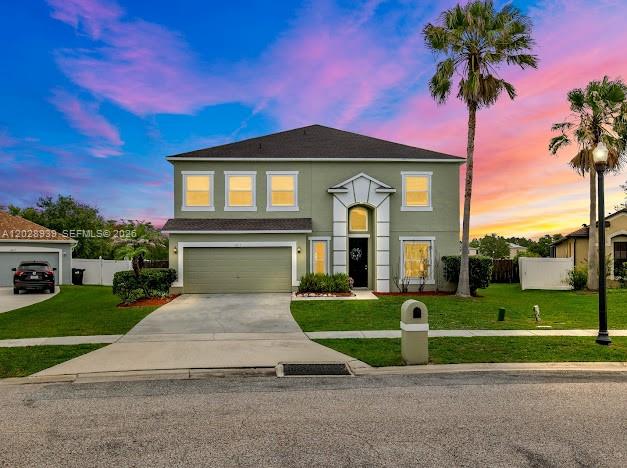 An open-concept living room and kitchen feature tile floors, dark leather furniture, and lake views — 2813 Village Pine Ter, Orlando FL 32833, ORLANDO, FL