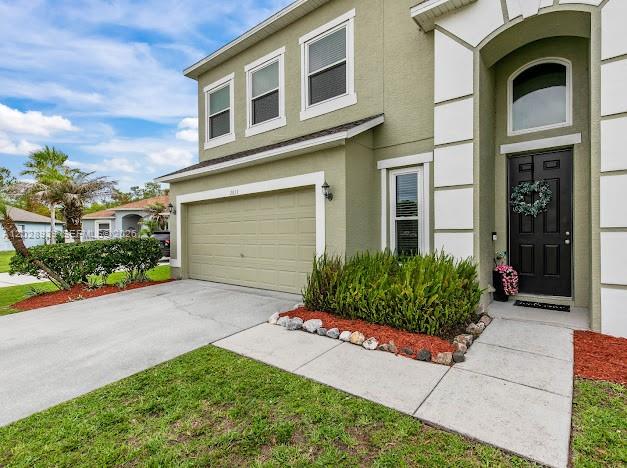 A kitchen island with granite countertops sits in an open-concept living area with tile floors — 2813 Village Pine Ter, Orlando FL 32833, ORLANDO, FL