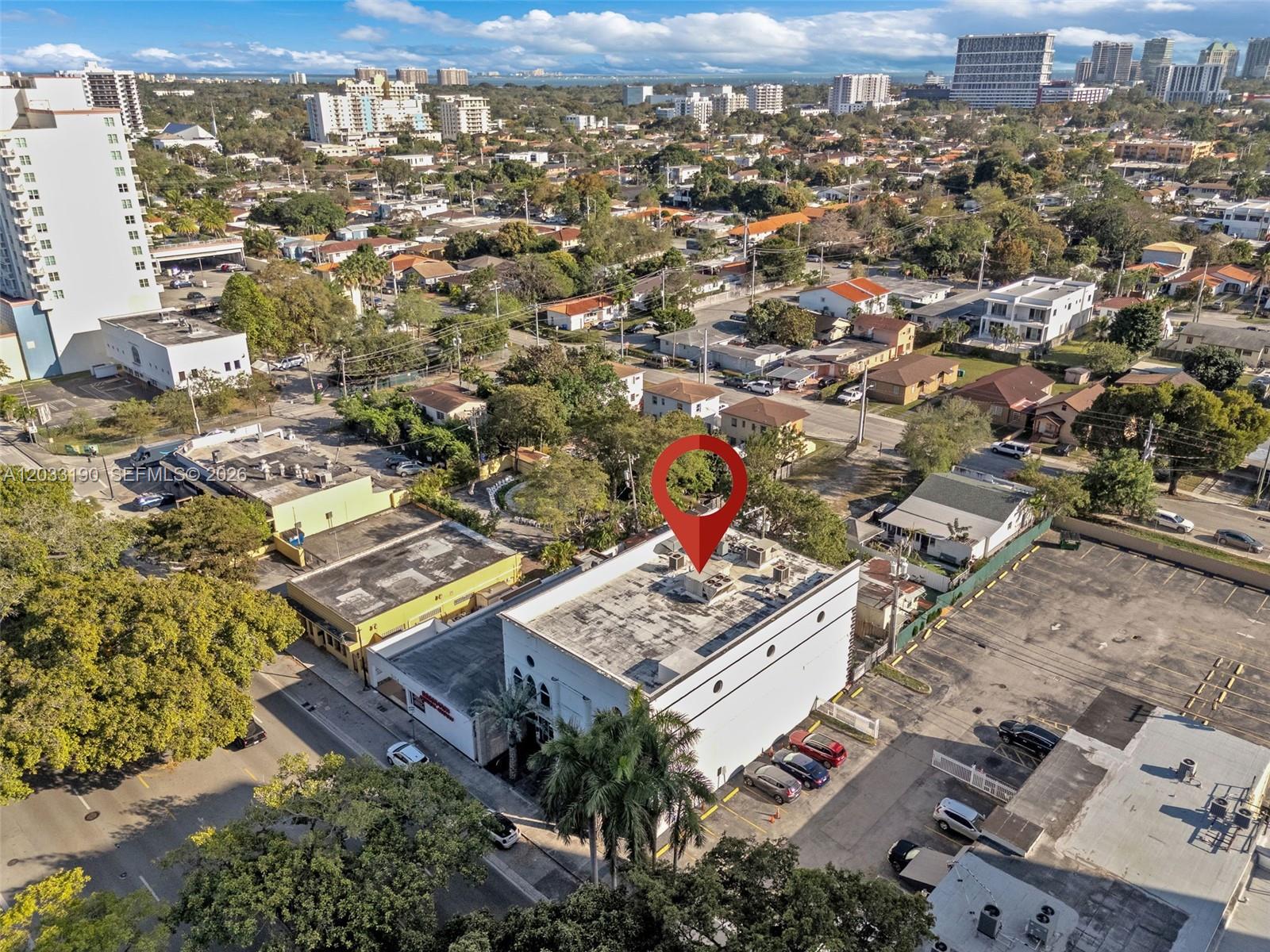 An aerial view shows a white commercial building with a flat roof and parking lot — 3138 Coral Way, Miami FL 33145, MIAMI, FL