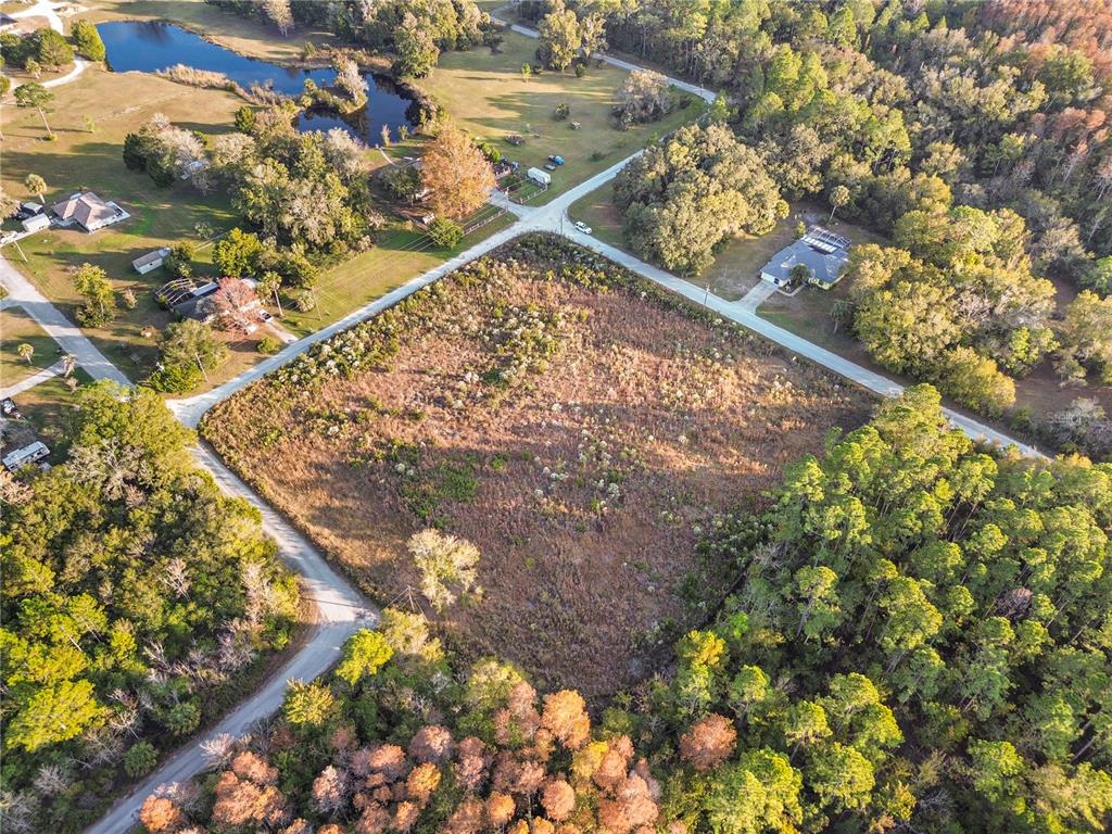 An aerial view shows a large, vacant, rectangular plot of land surrounded by trees and roads — 1146 N JORIE TERRACE, CRYSTAL RIVER, FL