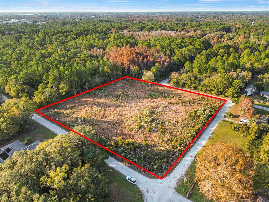 An aerial view shows a rectangular vacant lot outlined in red at a road intersection — 1146 N JORIE TERRACE, CRYSTAL RIVER, FL