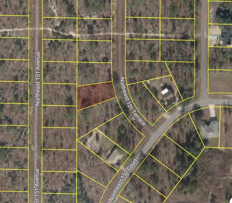 This aerial map shows a vacant, rectangular lot highlighted in red among surrounding wooded parcels — NE 151 TERRACE, WILLISTON, FL