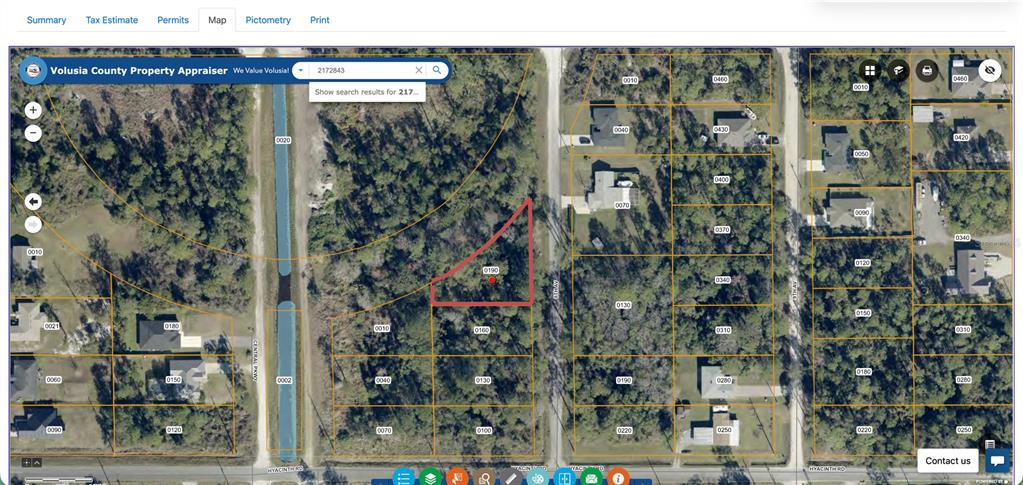 This is a satellite map view of a triangular parcel of land highlighted in red — 8TH AVENUE, DELAND, FL