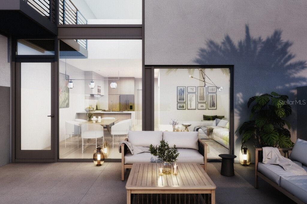 This rendering shows a modern patio with outdoor furniture looking into a bright interior living space — 2170 ROBINHOOD STREET UNIT A2-303, SARASOTA, FL