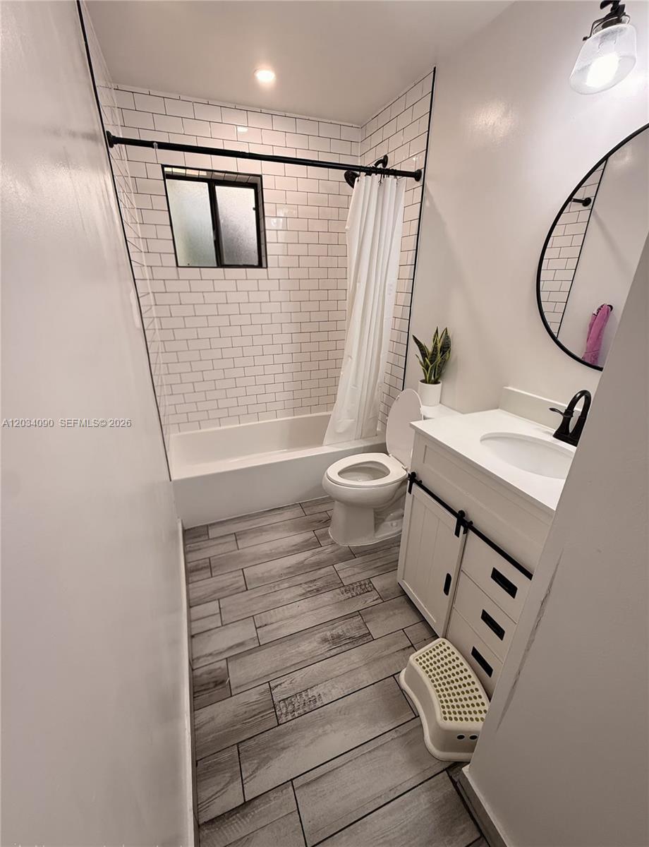A bathroom features a white vanity, a toilet, and a shower with white subway tiles — 8520 SW 133rd Ave Rd # 424, Miami FL 33183, MIAMI, FL