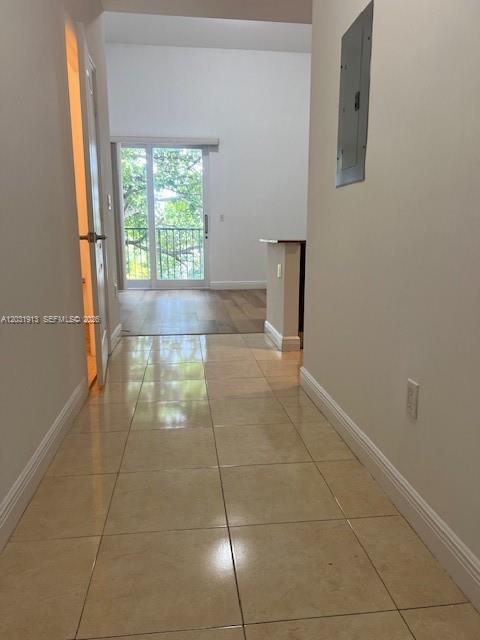A tiled hallway leads to a living area with a sliding glass door and balcony — 2701 SW 3rd Ave # 302, Miami FL 33129, MIAMI, FL