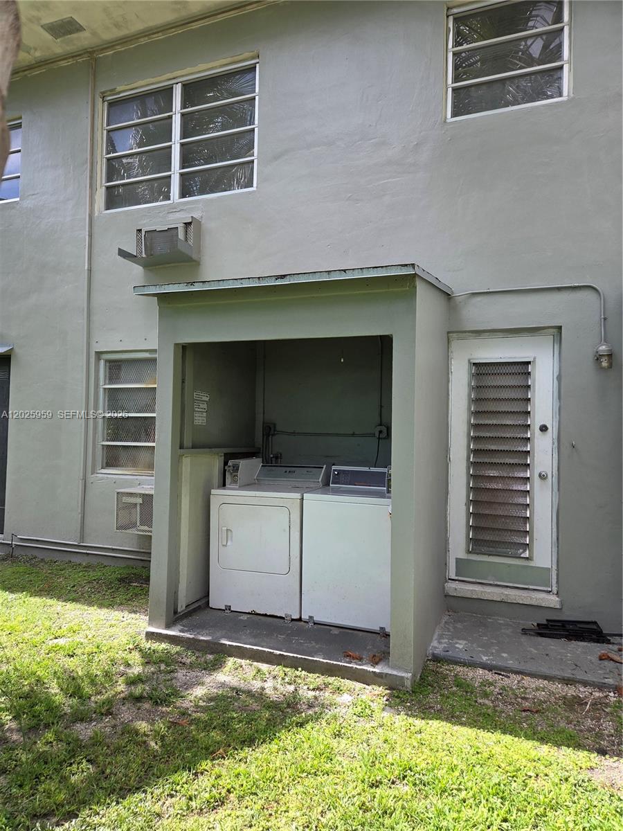An outdoor laundry area with a washer and dryer is located against a building exterior — 511 NE 82nd Ter, Miami FL 33138, MIAMI, FL