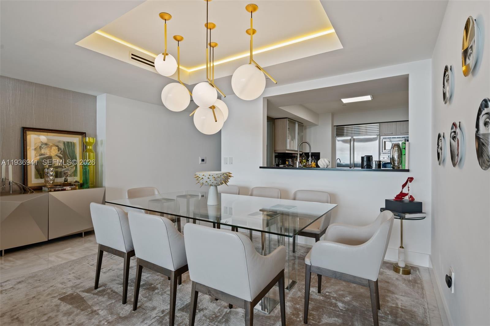 A modern dining room features a glass table, upholstered chairs, and a contemporary globe chandelier — 1331 Brickell Bay Dr # 2907, Miami FL 33131, MIAMI, FL