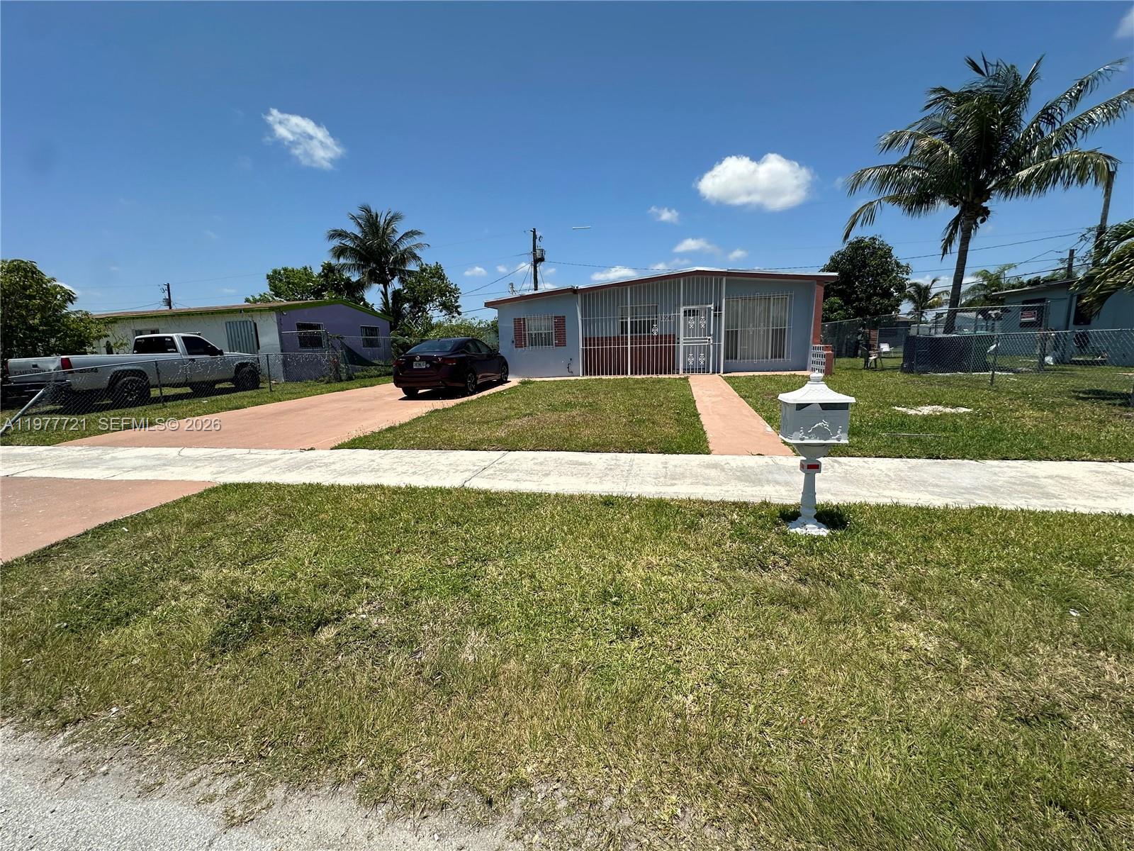 A single-story house with a driveway, a front lawn, and a white mailbox — 10761 SW 221st St, Miami FL 33170, MIAMI, FL