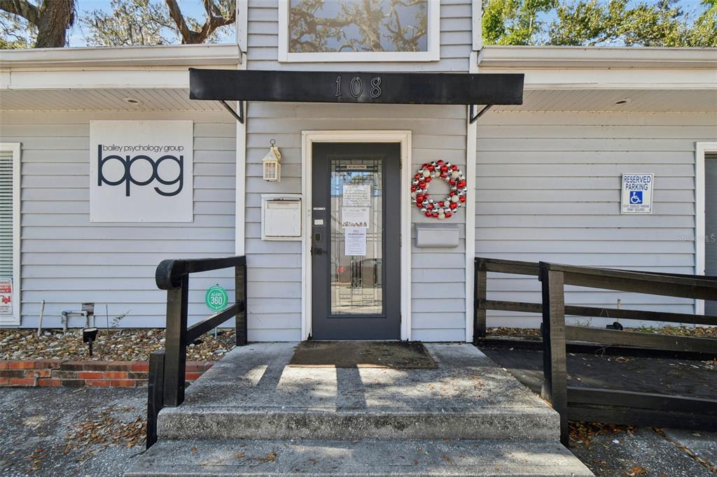 The exterior of a gray building features a front door with a holiday wreath — 108 4TH AVENUE S, SAFETY HARBOR, FL
