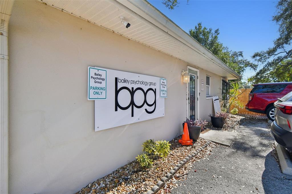 The exterior of a building features a large Bailey Psychology Group sign and parking area — 108 4TH AVENUE S, SAFETY HARBOR, FL