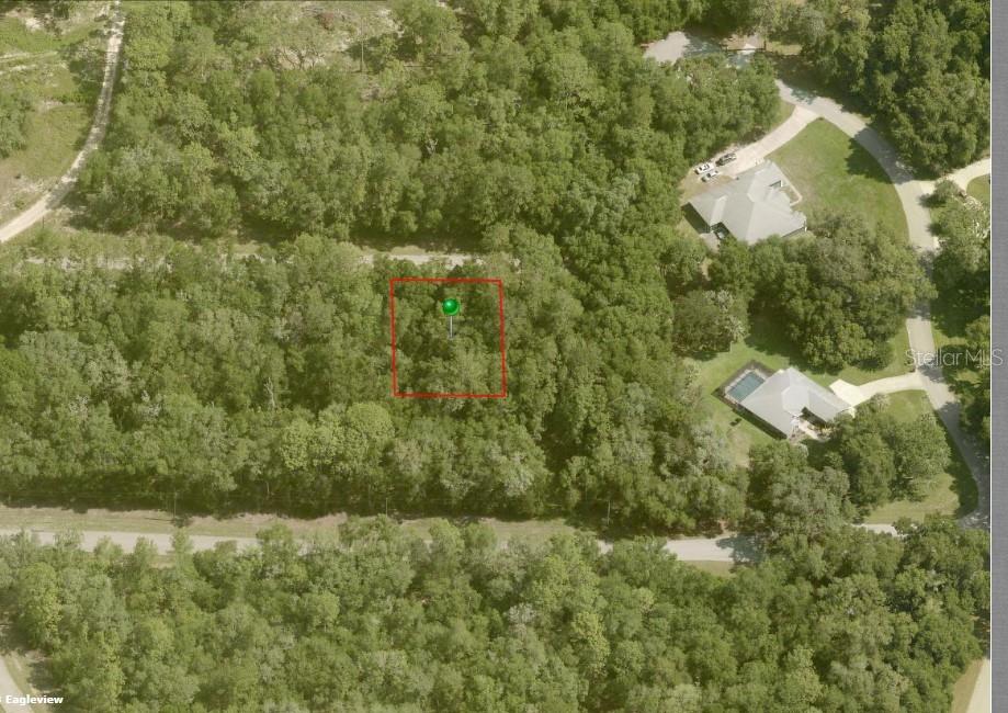 An aerial view shows a rectangular plot of land marked with a green pin — 282 W WHITMARSH COURT, DUNNELLON, FL