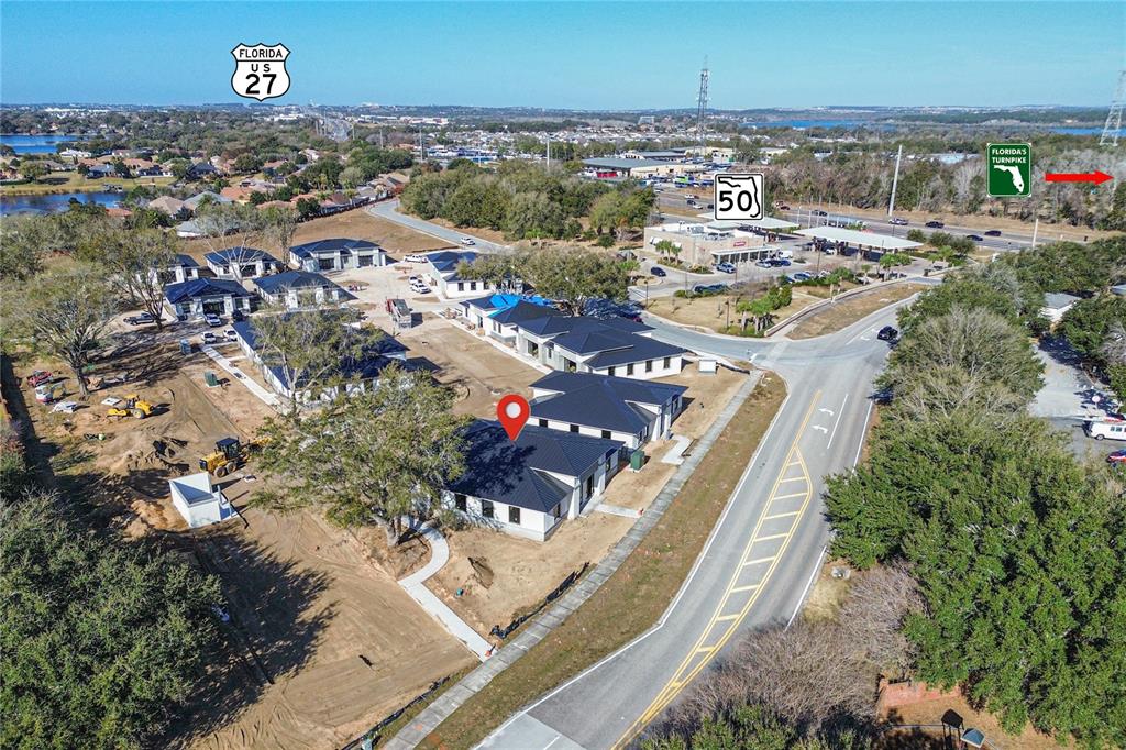 An aerial view shows a new residential development under construction near a highway intersection — 124 SOUTHERN RAILWAY UNIT 12, OAKLAND, FL