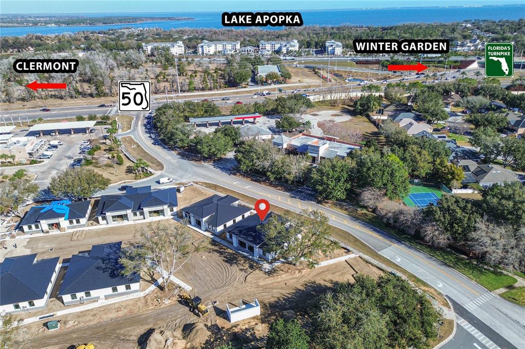 This aerial view shows a new residential development under construction near a major highway — 124 SOUTHERN RAILWAY UNIT 12, OAKLAND, FL