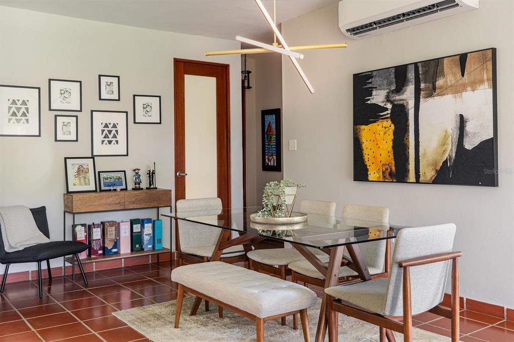 A dining room features a glass table, upholstered chairs, a bench, and a gallery wall — 2901 EL DORADO CLUB UNIT 2901, VEGA ALTA, PR