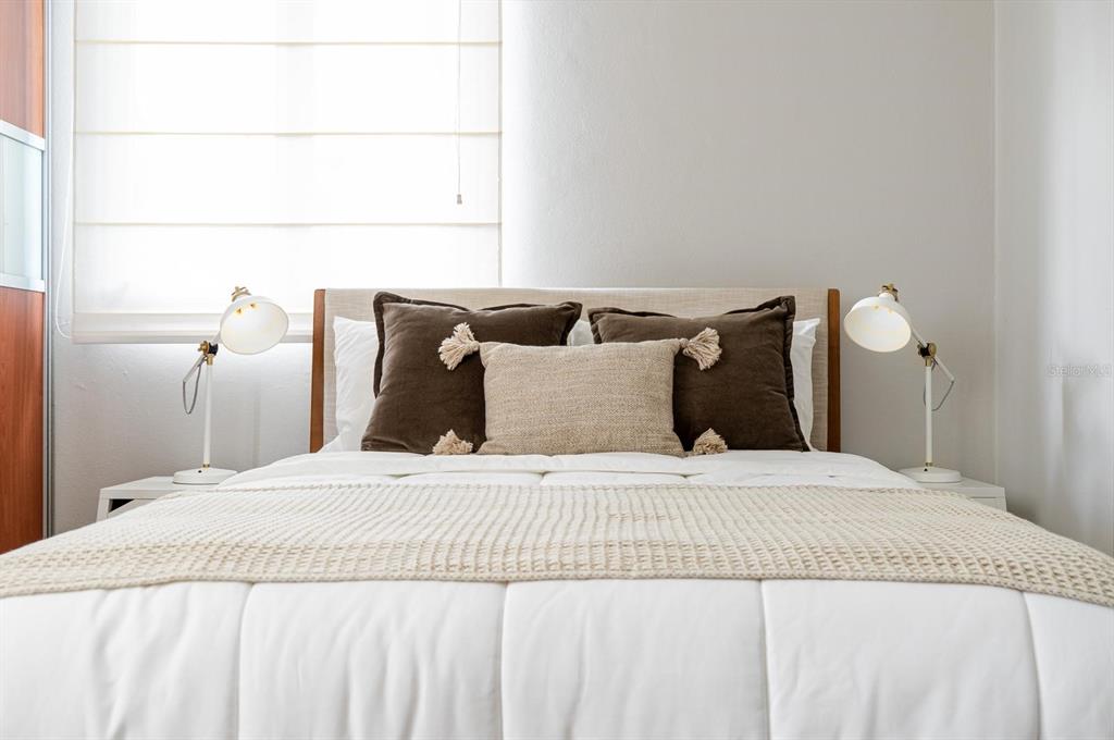 A bedroom features a bed with white bedding, dark brown pillows, and two white lamps — 2901 EL DORADO CLUB UNIT 2901, VEGA ALTA, PR
