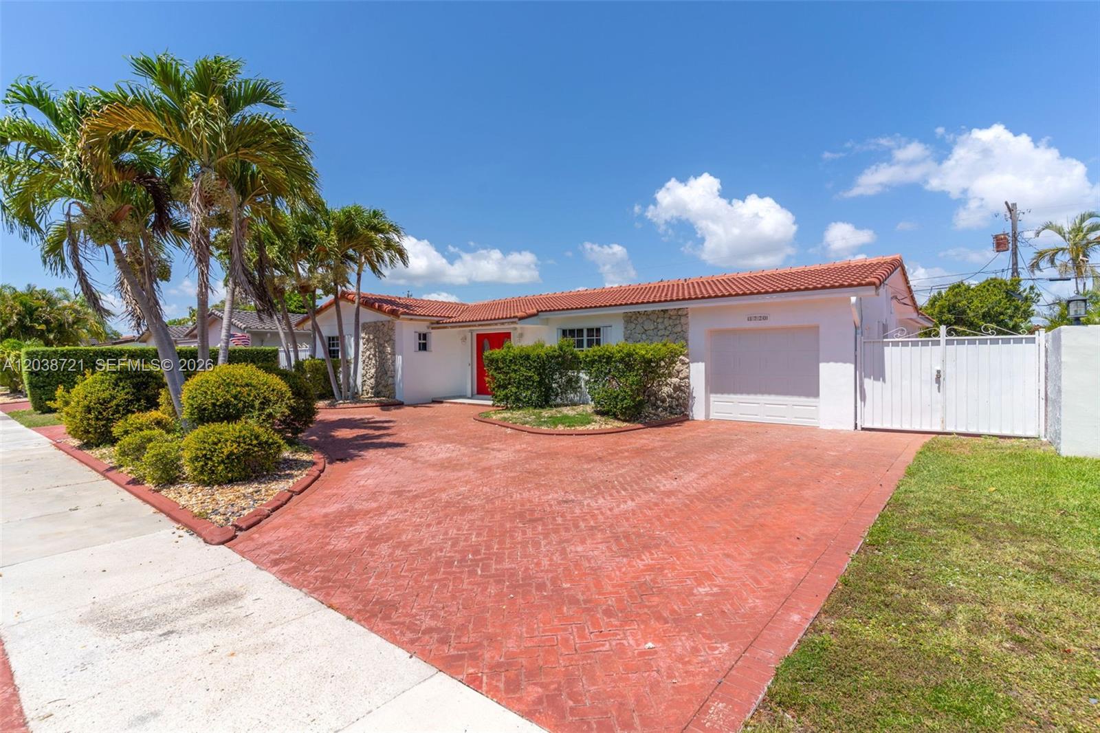 A single-story house features a red tiled roof, a red front door, and a brick driveway — 1720 SW 98th Ct, Miami FL 33165, MIAMI, FL