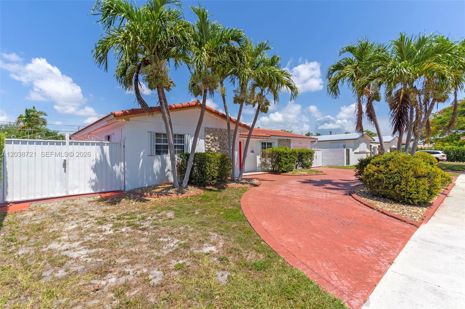 A single-story house with a red-tiled roof, palm trees, and a red brick driveway — 1720 SW 98th Ct, Miami FL 33165, MIAMI, FL