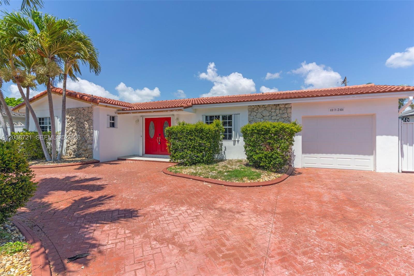 A single-story house with a red tile roof, white stucco walls, and a red door — 1720 SW 98th Ct, Miami FL 33165, MIAMI, FL