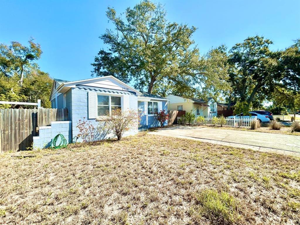 A light blue, single-story house with a concrete driveway and a large tree in front — 2720 EDWARDS AVENUE S, ST PETERSBURG, FL