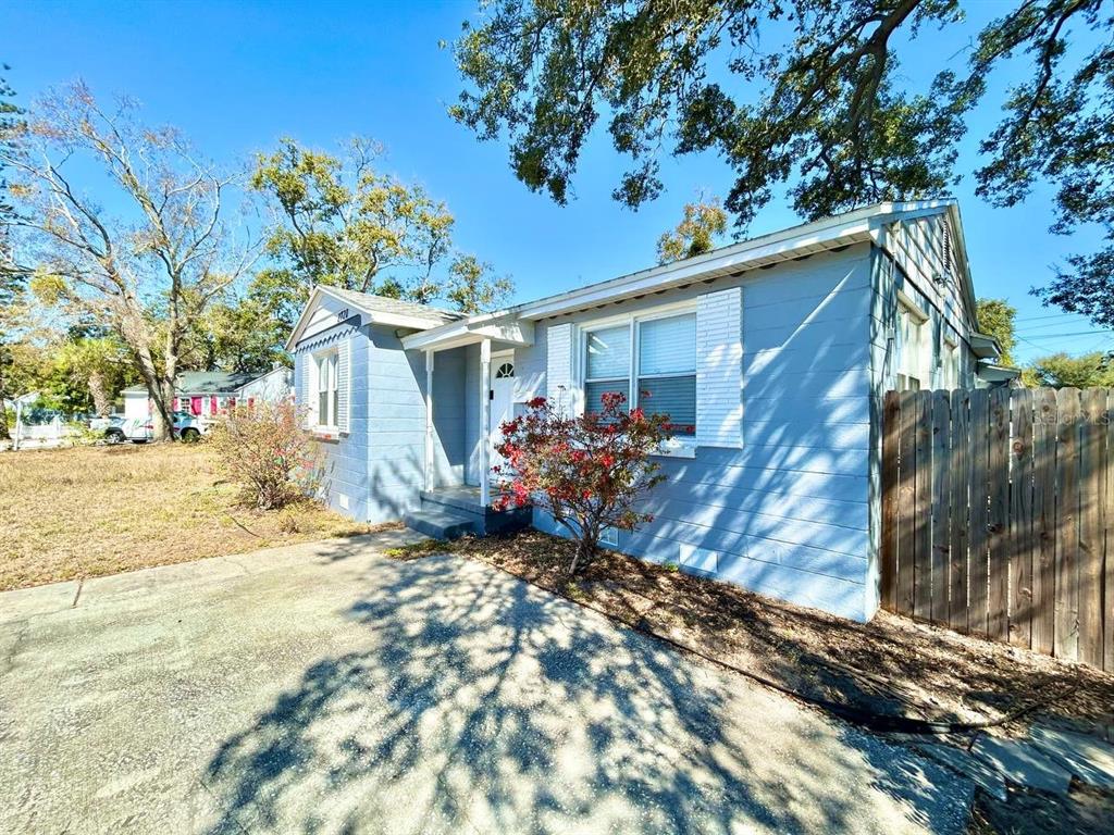 A light blue single-story house with a concrete driveway and a wooden fence — 2720 EDWARDS AVENUE S, ST PETERSBURG, FL