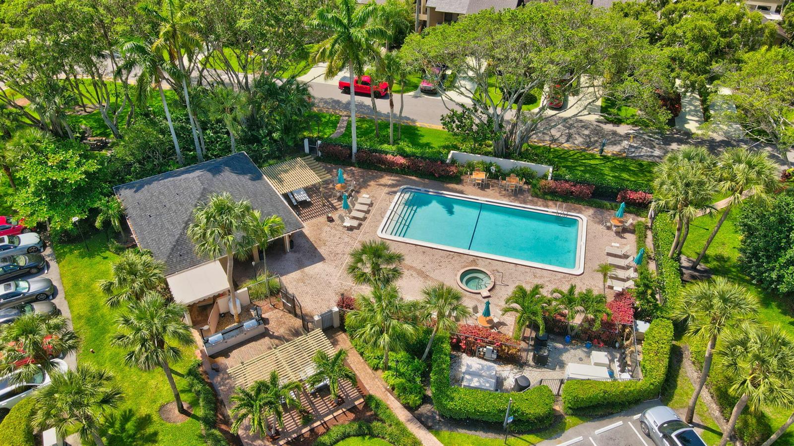 An aerial view of a community swimming pool, hot tub, clubhouse, and parking area — 6062 Glendale Drive, Boca Raton FL 33433, BOCA RATON, FL