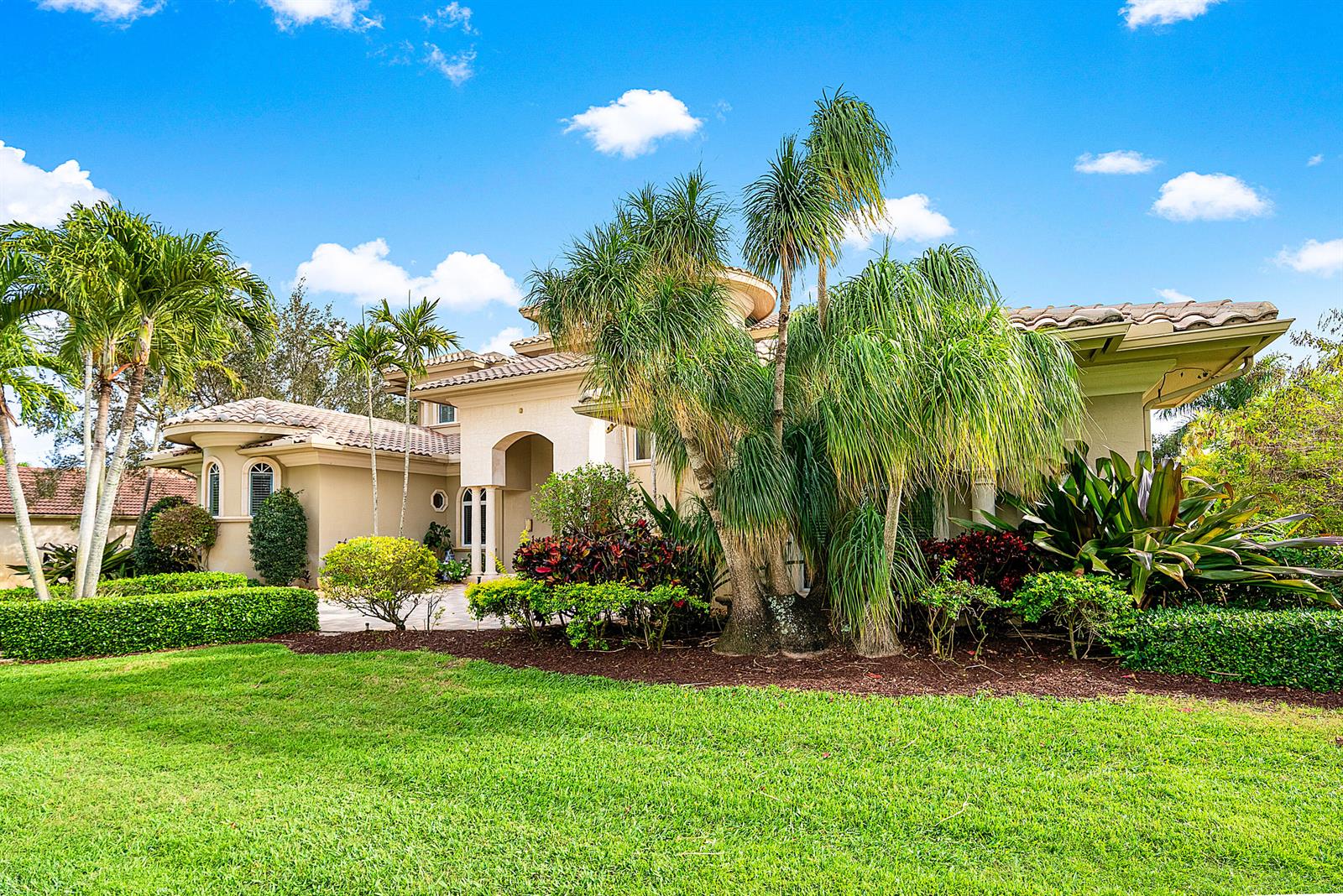 A beige stucco house with a tiled roof is surrounded by palm trees and landscaping — 4304 Saint Andrews Drive, Boynton Beach FL 33436, BOYNTON BEACH, FL