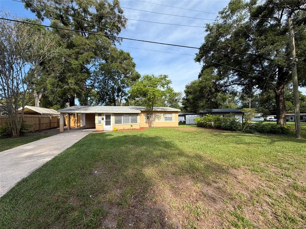A single-story house with a carport and a large front lawn under mature trees — 5318 S RIVER ROAD, JACKSONVILLE, FL