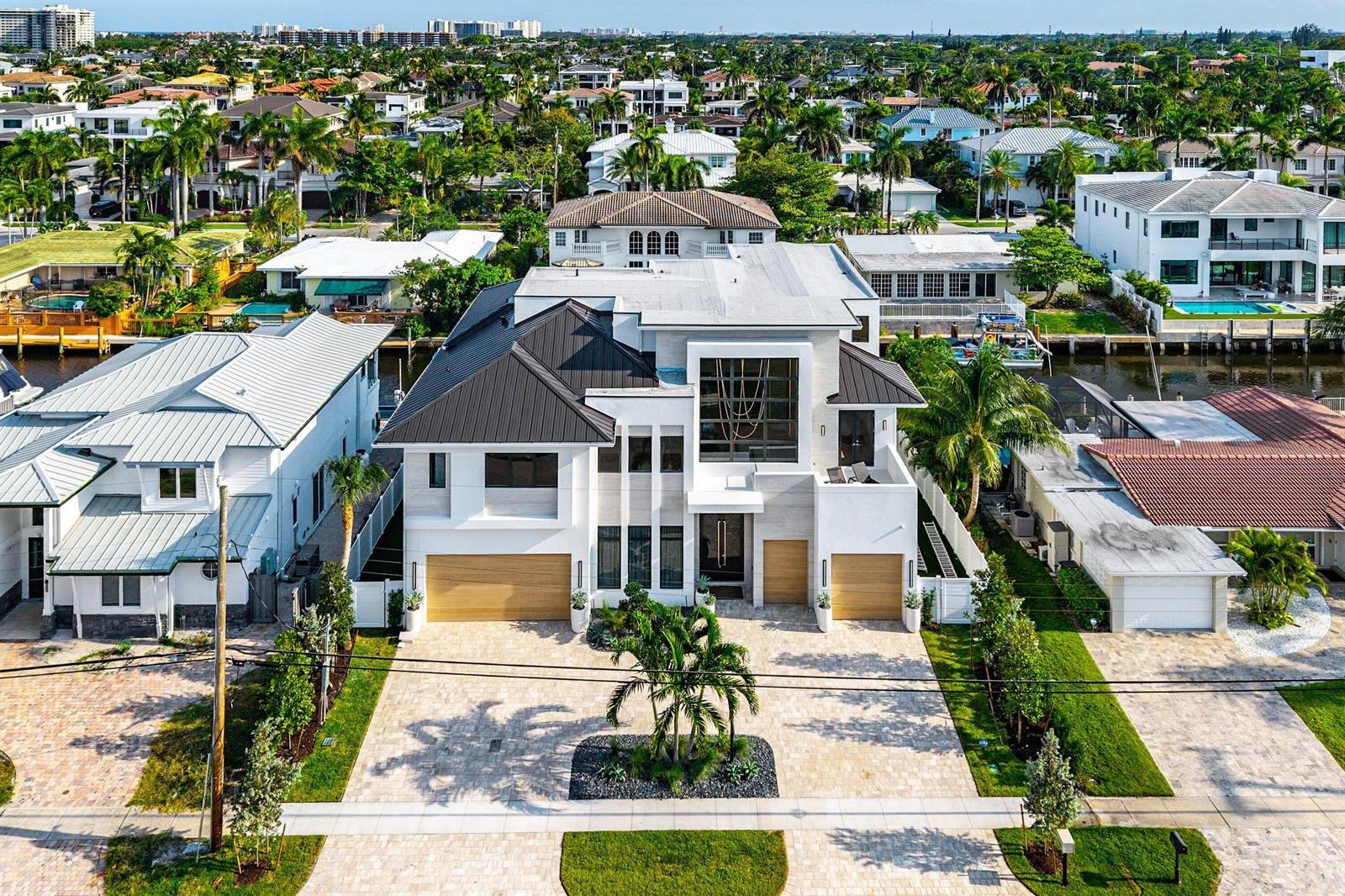 An aerial view of a modern two-story house with a metal roof and two garages — 748 NE 72nd Street, Boca Raton FL 33487, BOCA RATON, FL