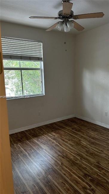 An empty bedroom with wood-look flooring, a ceiling fan, and a window with white blinds — 2851 W Prospect Rd # 1211, Tamarac FL 33309, TAMARAC, FL