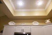 White kitchen cabinets topped with decorative white dishes sit beneath a recessed tray ceiling — 10875 Lake Front Place, Boca Raton FL 33498, BOCA RATON, FL