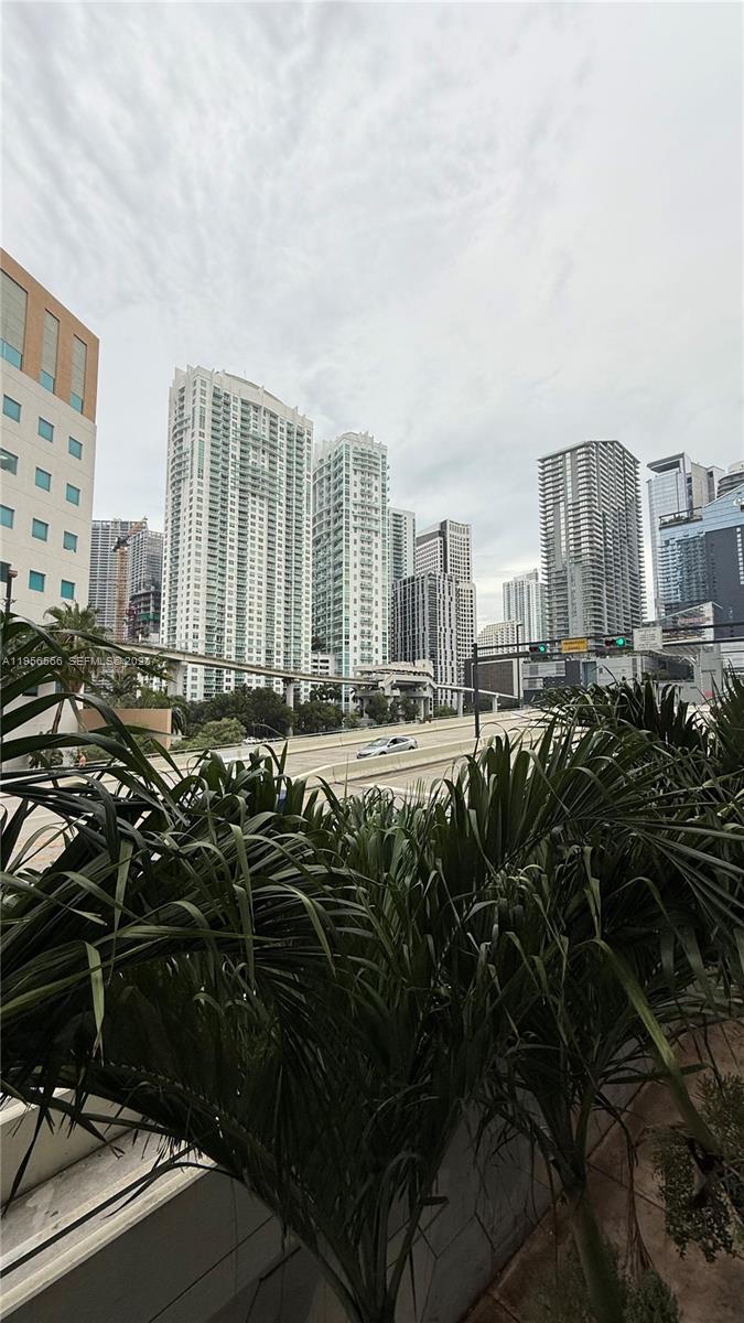 A view of a city skyline with skyscrapers and an elevated highway from a balcony — 350 S Miami Ave # 304, Miami FL 33130, MIAMI, FL