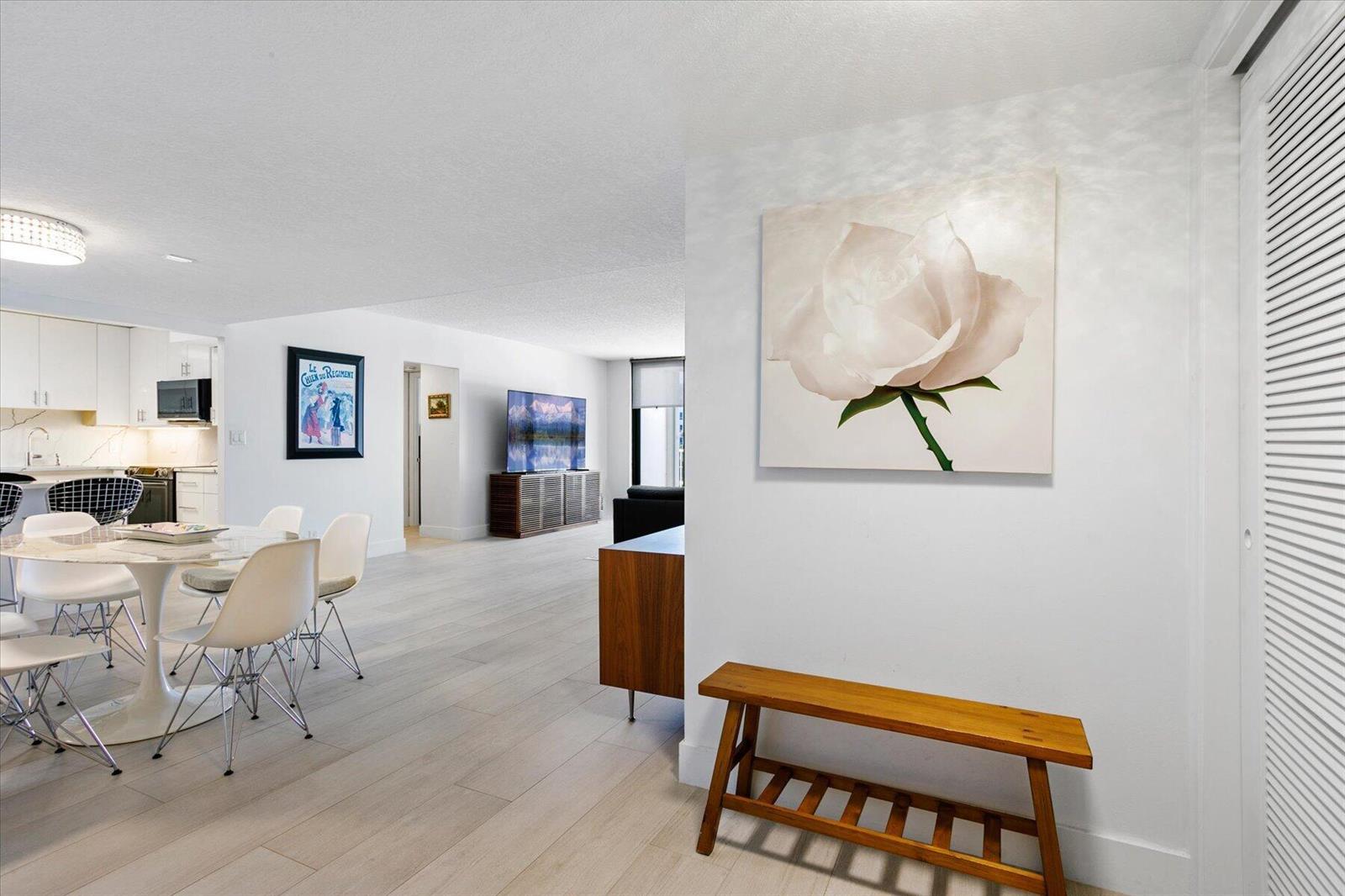 A dining area and living room feature white walls, light wood floors, and modern furniture — 2860 S Ocean Boulevard # 216, Palm Beach FL 33480, PALM BEACH, FL