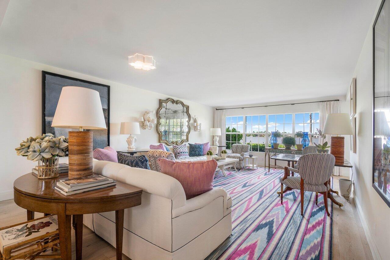 A bright living room features a patterned rug, white sofa, and large windows overlooking water — 2170 Ibis Isle Road # 3, Palm Beach FL 33480, PALM BEACH, FL