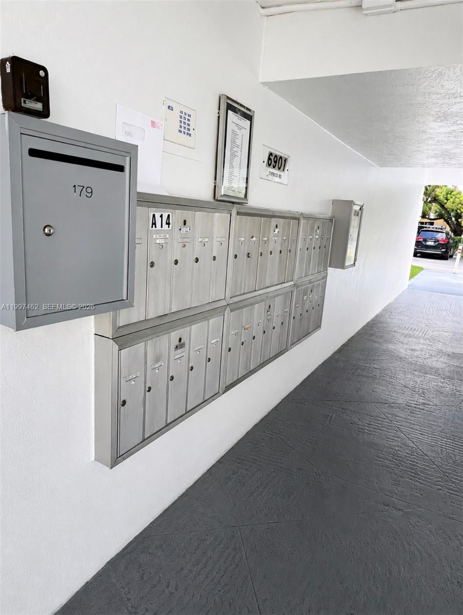 A wall-mounted bank of metal mailboxes is located in an outdoor covered walkway — 6901 Cypress Rd # B17, Plantation FL 33317, PLANTATION, FL